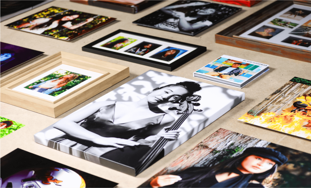 A collection of framed photographs and photo books displayed on a table.