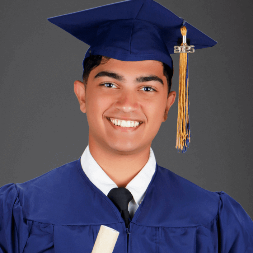 Graduates in black gowns and mortarboards at a ceremony.