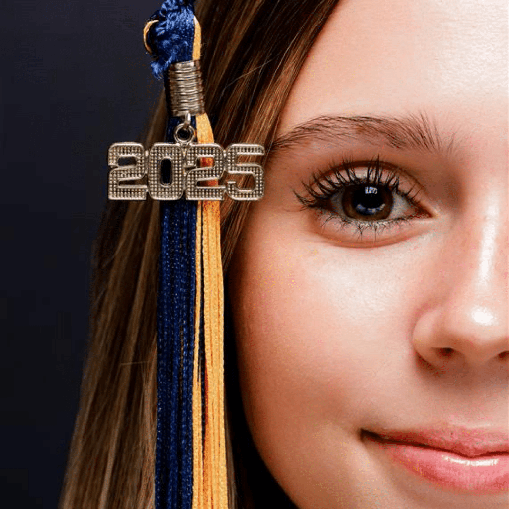 Graduation tassel with the year 2022 hanging next to a person's hair.